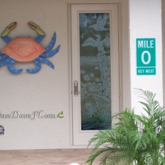 etched bathroom door glass with Anhinga on piling with etched pelican flying