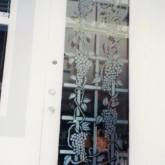 Grape vines etched on side entry door
