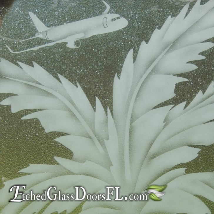 Microgranite glass door panel with sandblasted palm tree and airplane